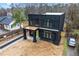 Modern home boasts a sleek black exterior, a covered porch, and a private driveway at 2402 Lynn Iris Dr, Decatur, GA 30032