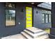Close-up of the home's modern black brick facade and vibrant yellow front door, creating a welcoming entrance at 2402 Lynn Iris Dr, Decatur, GA 30032