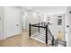 Upstairs hallway featuring wood floors and a black horizontal modern railing at 2402 Lynn Iris Dr, Decatur, GA 30032