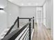 Hallway with wood floors and black railings overlooking the staircase at 2402 Lynn Iris Dr, Decatur, GA 30032