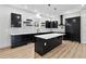 Modern kitchen featuring black cabinets, an island, and floating shelves provides a sleek and stylish design at 2402 Lynn Iris Dr, Decatur, GA 30032