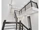 Bright, multi-story staircase with contemporary black metal railings and white risers at 2402 Lynn Iris Dr, Decatur, GA 30032