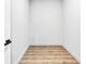 Interior of walk-in closet with light hardwood floors and a white door at 2402 Lynn Iris Dr, Decatur, GA 30032