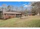 Back view of single-story home with a spacious yard, showcasing exterior and surroundings at 2807 Knollview Dr, Decatur, GA 30034
