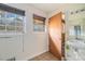 Modest bathroom with a large window, tile flooring, single sink vanity and access to another room at 2807 Knollview Dr, Decatur, GA 30034