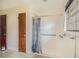 Shower room with tiled floor and walls, a hand-held shower and a grab bar for accessibility at 2807 Knollview Dr, Decatur, GA 30034