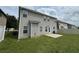 Exterior shot of the back of a home in a suburban neighborhood with a concrete patio and grassy lawn at 3592 Hancock Vw, Decatur, GA 30034