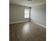 Neutral bedroom offers natural light and wood-look laminate flooring at 3592 Hancock Vw, Decatur, GA 30034