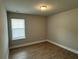 Cozy bedroom features neutral paint and durable laminate flooring at 3592 Hancock Vw, Decatur, GA 30034