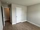 A minimalist bedroom features wood-look flooring and a closed white closet door at 3592 Hancock Vw, Decatur, GA 30034
