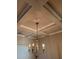 Close-up of a coffered ceiling with decorative trim, recessed lighting, and an elegant chandelier at 3592 Hancock Vw, Decatur, GA 30034