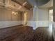 Elegant dining room showcasing hardwood floors, coffered ceilings, wainscotting, and a stylish chandelier at 3592 Hancock Vw, Decatur, GA 30034