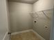 Functional laundry room features durable tile flooring and wire shelf at 3592 Hancock Vw, Decatur, GA 30034