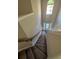 Carpeted stairway leading to a bright foyer with a decorative window and front door at 3592 Hancock Vw, Decatur, GA 30034