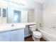 Well-lit bathroom featuring a white sink vanity, toilet, and a shower-tub combo at 414 Ridge Creek Dr, Clarkston, GA 30021