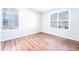 A bedroom with hardwood floors and two windows with blinds that provide natural light at 414 Ridge Creek Dr, Clarkston, GA 30021