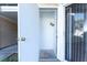 A small entryway with a concrete floor and a metal shade hanging from the ceiling at 414 Ridge Creek Dr, Clarkston, GA 30021