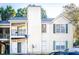 View of a two-story condo featuring a small balcony and light-colored siding with green shutters at 414 Ridge Creek Dr, Clarkston, GA 30021