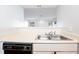 Close-up of a kitchen sink and vintage dishwasher, showcasing the kitchen's layout at 414 Ridge Creek Dr, Clarkston, GA 30021