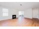 A living room with hardwood floors, a fireplace, and a sliding glass door at 414 Ridge Creek Dr, Clarkston, GA 30021