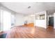 Open concept living area with wood-look flooring, access to the kitchen, and sliding glass doors to the patio at 414 Ridge Creek Dr, Clarkston, GA 30021