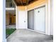 View of an outdoor patio area with a concrete floor, sliding glass door, and white vertical blinds at 414 Ridge Creek Dr, Clarkston, GA 30021