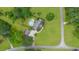 Aerial view of a lovely estate, featuring a large home, swimming pool, and detached garage on a verdant lawn at 130 Plantation Dr, Stockbridge, GA 30281
