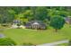 A beautiful brick two-story home with a three-car detached garage, surrounded by a well-manicured green lawn at 130 Plantation Dr, Stockbridge, GA 30281