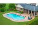 An overhead perspective of the home's swimming pool with steps, patio, and well-maintained backyard at 130 Plantation Dr, Stockbridge, GA 30281