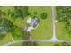 Aerial view of a lovely estate, featuring a large home, swimming pool, and detached garage on a verdant lawn at 130 Plantation Dr, Stockbridge, GA 30281