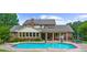 A view of the large in-ground pool with adjacent patio and lush lawn, ideal for outdoor entertainment and relaxation at 130 Plantation Dr, Stockbridge, GA 30281
