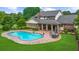 Aerial view of a backyard featuring a pool, patio, and lush green lawn, ideal for outdoor enjoyment at 130 Plantation Dr, Stockbridge, GA 30281