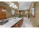 Full bathroom featuring dual sinks, a large mirror, and soaking tub at 130 Plantation Dr, Stockbridge, GA 30281