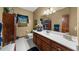 Bathroom features a large vanity with double sinks and decorative accents. Window provides natural light at 130 Plantation Dr, Stockbridge, GA 30281