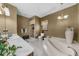 Full bathroom with dual sinks, soaking tub, glass shower, and separate toilet at 130 Plantation Dr, Stockbridge, GA 30281