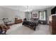 Well-lit bedroom features carpet, neutral walls, traditional furniture and large windows at 130 Plantation Dr, Stockbridge, GA 30281