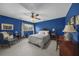 Stylish bedroom with blue walls, natural light, and a comfortable seating area at 130 Plantation Dr, Stockbridge, GA 30281