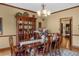 Formal dining room with a china cabinet, hardwood floors, and a table set for six at 130 Plantation Dr, Stockbridge, GA 30281