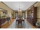 Formal dining room with hardwood floors, a china cabinet, and a long rug under the table at 130 Plantation Dr, Stockbridge, GA 30281