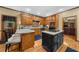 Traditional kitchen featuring wood cabinetry, granite countertops, kitchen island and hardwood flooring at 130 Plantation Dr, Stockbridge, GA 30281