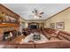 Spacious living room showcasing a brick fireplace, ceiling fan, and comfortable leather seating at 130 Plantation Dr, Stockbridge, GA 30281