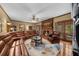 Inviting living room with a cozy brick fireplace and a large leather sectional sofa at 130 Plantation Dr, Stockbridge, GA 30281