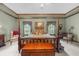 Stunning main bedroom featuring a four poster bed, tray ceilings, and neutral carpeting at 130 Plantation Dr, Stockbridge, GA 30281