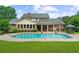 Back exterior view showcasing a large pool and beautifully maintained grounds, great for outdoor activities at 130 Plantation Dr, Stockbridge, GA 30281