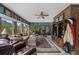 Bright sunroom with large windows, brick wall accents, and comfortable seating area at 130 Plantation Dr, Stockbridge, GA 30281