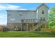 Beautiful backyard featuring a well-maintained lawn, lower patio and back deck at 15 Manas Ct, Covington, GA 30016