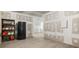 Unfinished basement with modern floors and a refrigerator at 15 Manas Ct, Covington, GA 30016