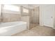 Modern bathroom with soaking tub and glass-enclosed shower at 15 Manas Ct, Covington, GA 30016