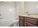 Bathroom features a double vanity, tiled floor, tub, and shower at 15 Manas Ct, Covington, GA 30016