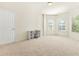 Spacious bedroom with neutral carpet, white walls, and a built-in desk and shelving unit at 15 Manas Ct, Covington, GA 30016